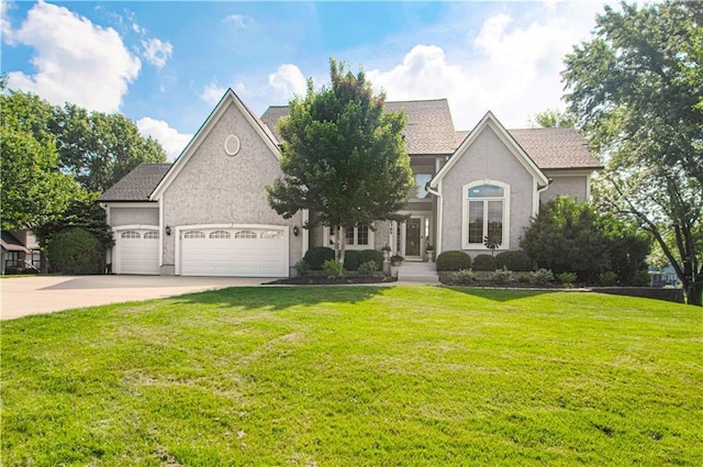 18765 S Alden St, Olathe, KS 66062 - view of front of home featuring a garage, a front lawn, and concrete driveway