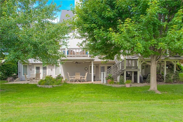 18765 S Alden St, Olathe, KS 66062 - rear view of property with a wooden deck, a lawn, and a patio area