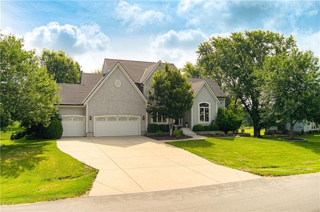 18765 S Alden St, Olathe, KS 66062 - view of front of home featuring concrete driveway, a garage, a front yard, and stucco siding