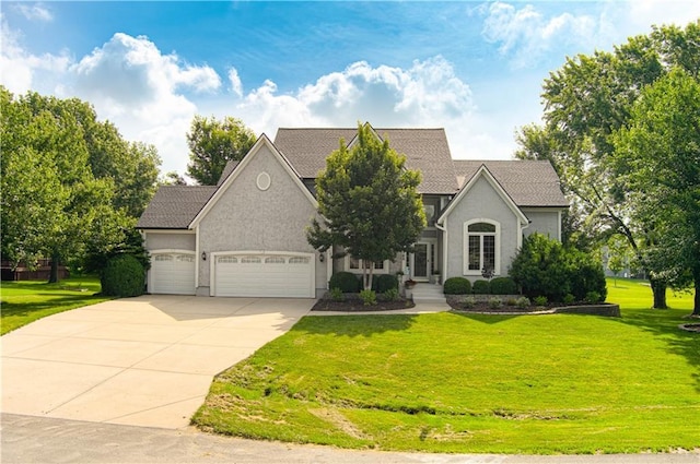 18765 S Alden St, Olathe, KS 66062 - view of front of house with concrete driveway, a garage, stucco siding, and a front yard