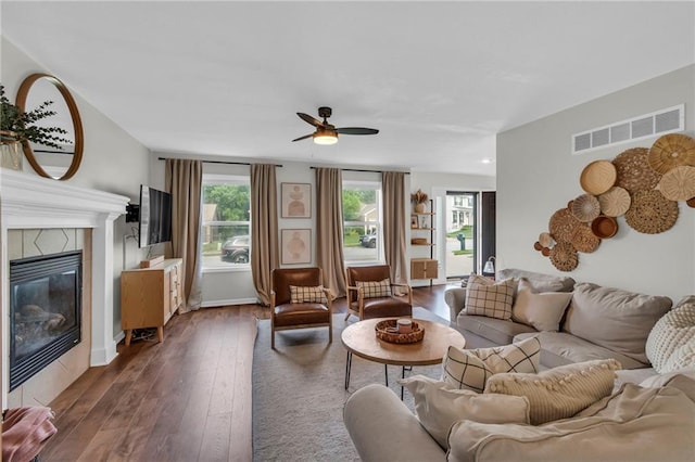 1610 Renea Ct, Kearney, MO 64060 - living area with dark wood-type flooring, a ceiling fan, and a fireplace