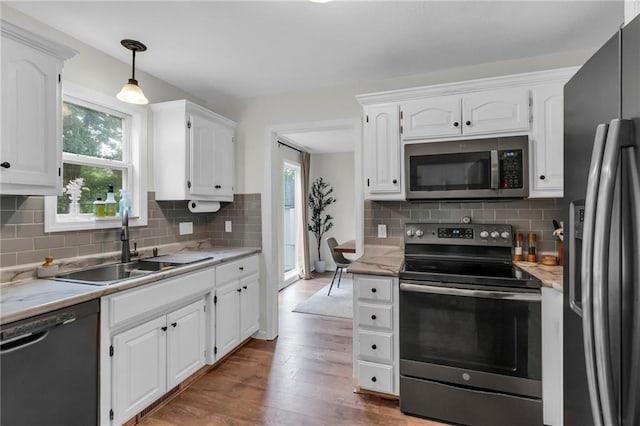 1610 Renea Ct, Kearney, MO 64060 - kitchen with appliances with stainless steel finishes, wood finished floors, a sink, and white cabinets