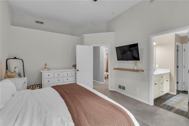 1610 Renea Ct, Kearney, MO 64060 - carpeted bedroom with baseboards, ensuite bathroom, and lofted ceiling