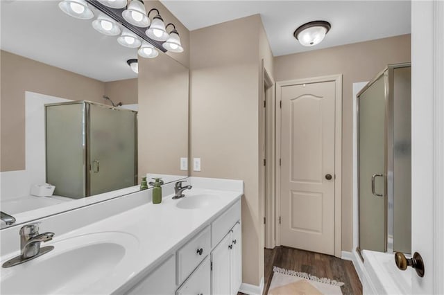 1610 Renea Ct, Kearney, MO 64060 - bathroom with a shower stall, double vanity, and wood finished floors