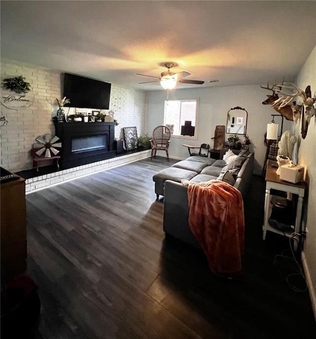 414 S 3rd St, Humboldt, KS 66748 - living room featuring dark wood-style flooring, a glass covered fireplace, and a ceiling fan