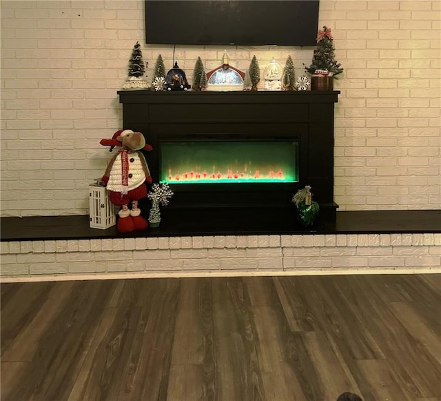 414 S 3rd St, Humboldt, KS 66748 - detailed view of a brick fireplace, brick wall, and wood finished floors
