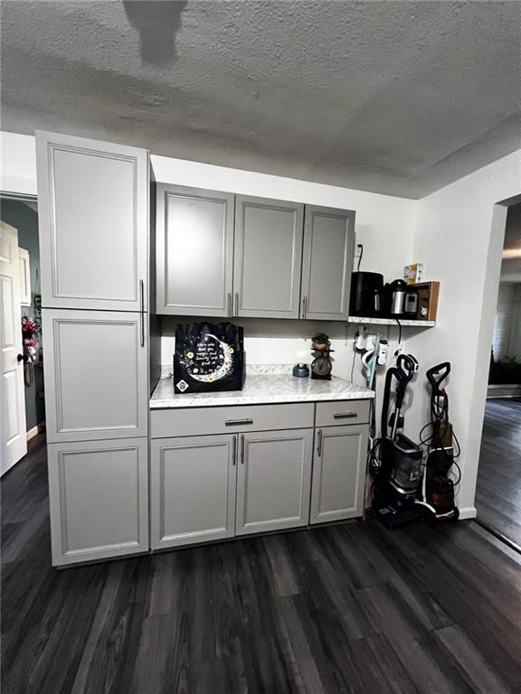 414 S 3rd St, Humboldt, KS 66748 - bar area featuring dark wood-style floors and a textured ceiling