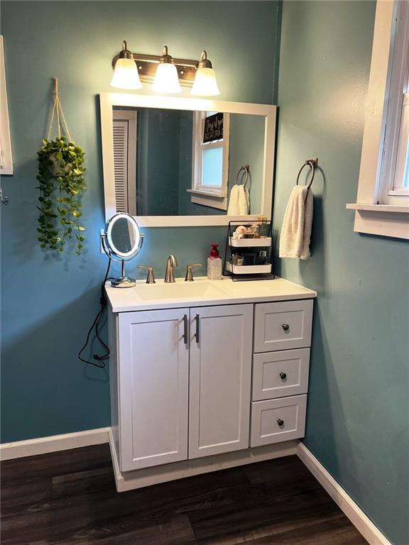 414 S 3rd St, Humboldt, KS 66748 - bathroom featuring vanity and wood finished floors