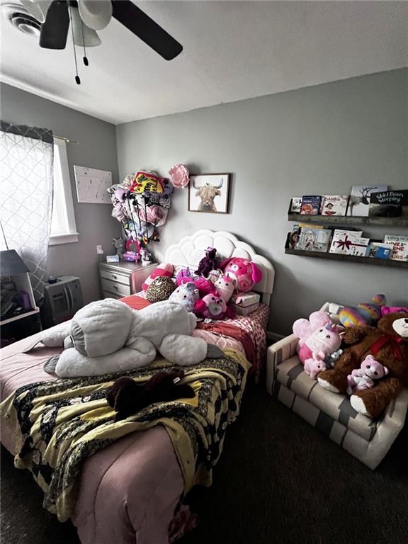 414 S 3rd St, Humboldt, KS 66748 - carpeted bedroom with a ceiling fan