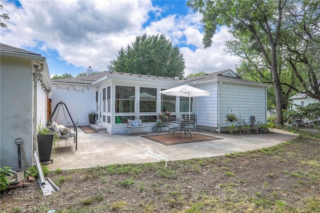 115 NE Green St, Lees Summit, MO 64063 - rear view of property featuring a patio area, a shingled roof, and a chimney