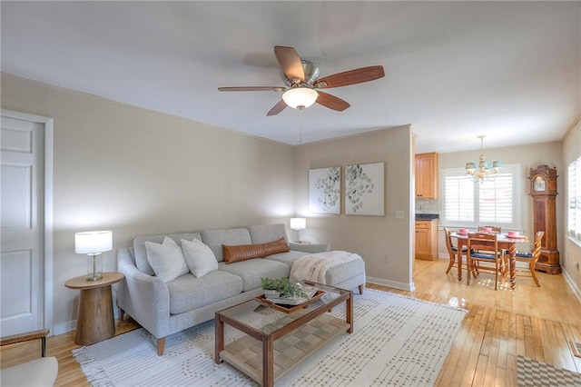 115 NE Green St, Lees Summit, MO 64063 - living area featuring a chandelier, ceiling fan, and light wood-style floors