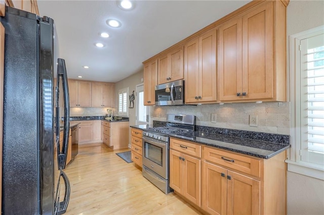 115 NE Green St, Lees Summit, MO 64063 - kitchen featuring appliances with stainless steel finishes, light wood-type flooring, healthy amount of natural light, tasteful backsplash, and recessed lighting