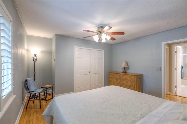 115 NE Green St, Lees Summit, MO 64063 - bedroom with light wood-style flooring, a closet, and ceiling fan