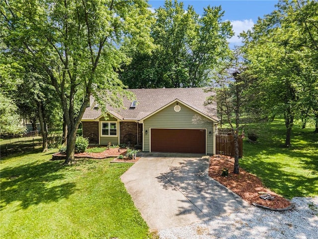307 E Gore Rd, Raymore, MO 64083 - view of front of home with driveway, an attached garage, a shingled roof, and brick siding