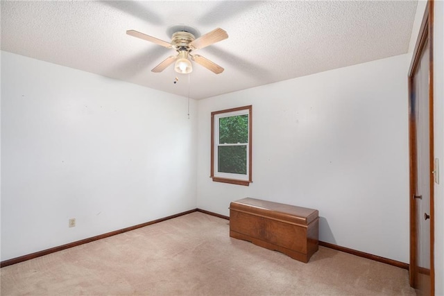 307 E Gore Rd, Raymore, MO 64083 - unfurnished room with carpet, ceiling fan, a textured ceiling, and baseboards