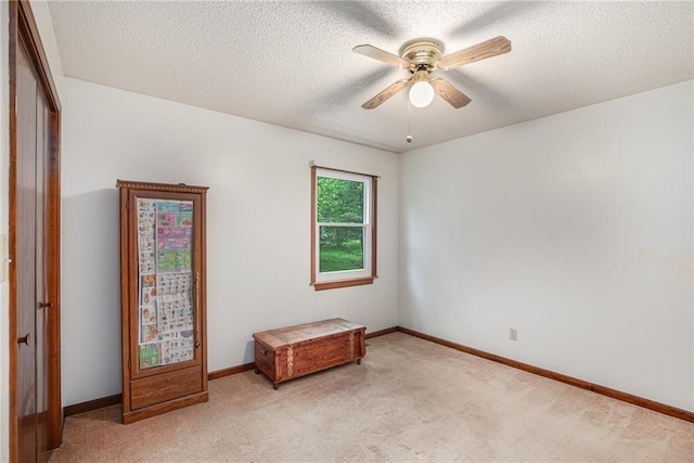 307 E Gore Rd, Raymore, MO 64083 - carpeted empty room featuring ceiling fan, a textured ceiling, and baseboards
