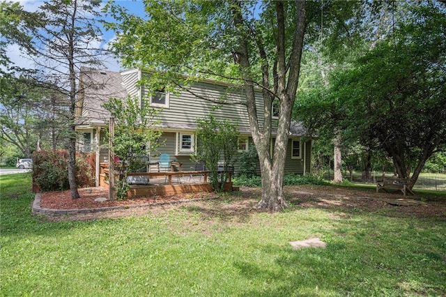 307 E Gore Rd, Raymore, MO 64083 - view of home's exterior with a lawn and a deck