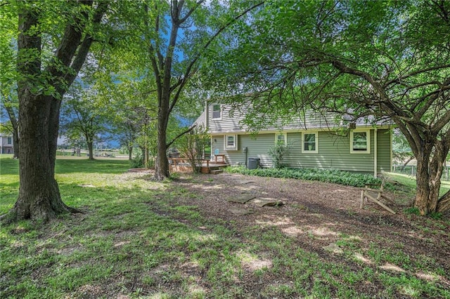 307 E Gore Rd, Raymore, MO 64083 - view of green lawn featuring a deck and cooling unit