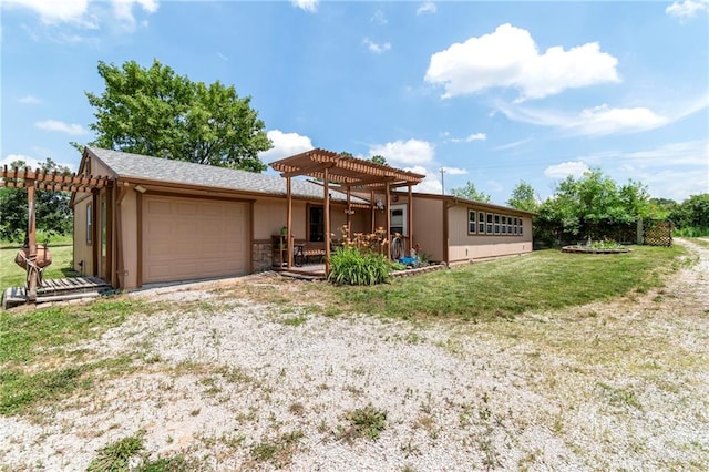 5470 SE Downing Rd, Lathrop, MO 64465 - view of front of house featuring a pergola, a garage, a front lawn, and stone siding