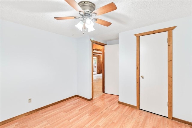 5470 SE Downing Rd, Lathrop, MO 64465 - unfurnished bedroom with light wood-type flooring, a textured ceiling, and a ceiling fan