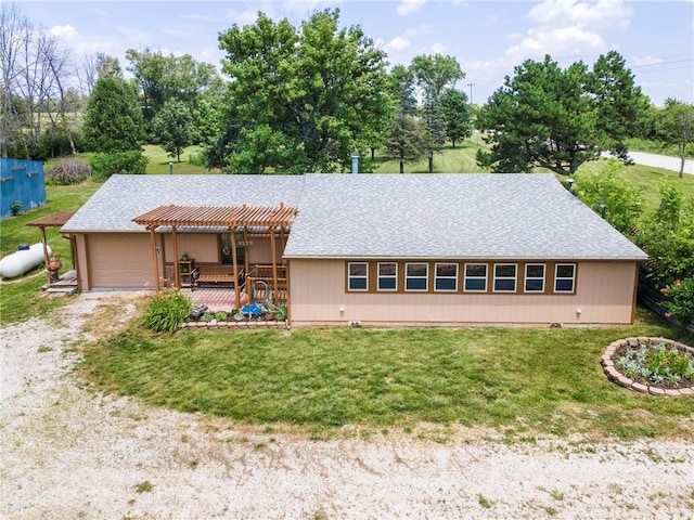 5470 SE Downing Rd, Lathrop, MO 64465 - view of front facade with a front yard, a wooden deck, a pergola, and driveway