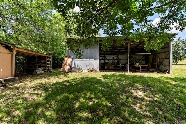 5470 SE Downing Rd, Lathrop, MO 64465 - view of grassy yard featuring a pole building and an outbuilding