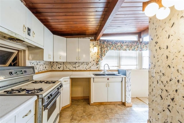 11120 E 35th Ter, Independence, MO 64052 - kitchen featuring white gas range oven, a wood ceiling with exposed beams, light countertops, and white cabinetry