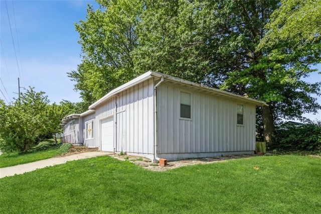 11120 E 35th Ter, Independence, MO 64052 - view of home's exterior featuring board and batten siding, a yard, driveway, and a garage