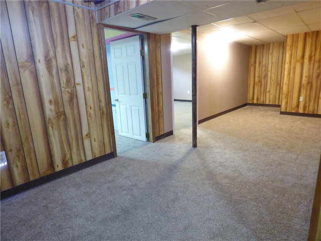 520 N Jefferson St, Raymore, MO 64030 - finished below grade area featuring carpet, wood walls, and baseboards