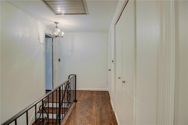 9920 Juniper Ln, Overland Park, KS 66207 - corridor featuring a chandelier, wood finished floors, and baseboards