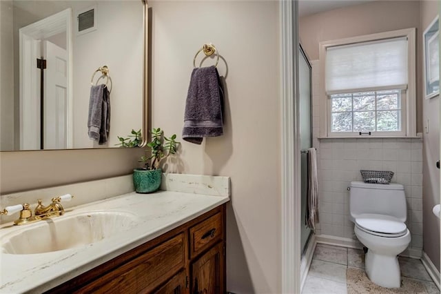 732 W 121st St, Kansas City, MO 64145 - bathroom with vanity, a shower with shower door, tile patterned flooring, and tile walls