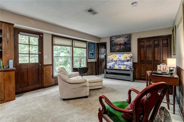 732 W 121st St, Kansas City, MO 64145 - carpeted living area featuring a wainscoted wall and wooden walls