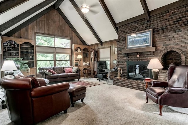 732 W 121st St, Kansas City, MO 64145 - carpeted living room featuring a brick fireplace, wooden walls, beamed ceiling, high vaulted ceiling, and a ceiling fan
