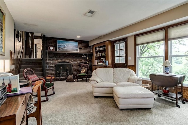 732 W 121st St, Kansas City, MO 64145 - carpeted living area featuring a brick fireplace, wainscoting, and wooden walls