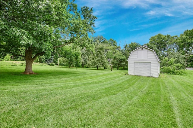 3200 NW 51st Ter, Blue Springs, MO 64015 - view of grassy yard with an outbuilding, a garage, and view of wooded area