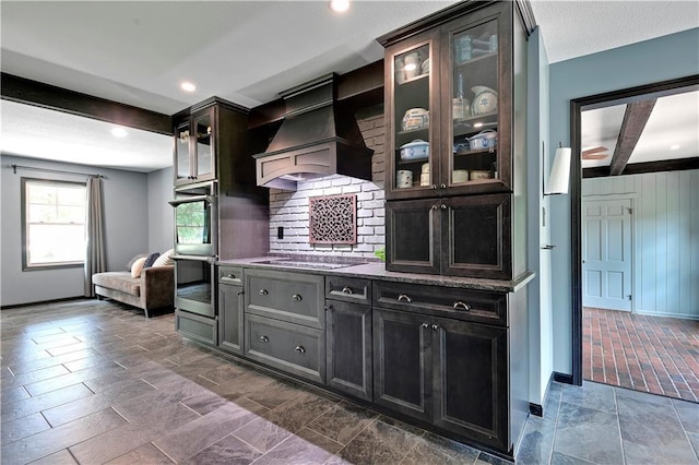 3200 NW 51st Ter, Blue Springs, MO 64015 - kitchen with range hood, beamed ceiling, stovetop, glass insert cabinets, and double oven