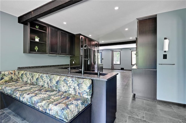 3200 NW 51st Ter, Blue Springs, MO 64015 - kitchen featuring recessed lighting, dark stone countertops, dark brown cabinetry, and a peninsula