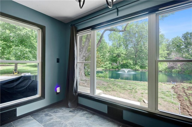 3200 NW 51st Ter, Blue Springs, MO 64015 - entryway with a water view, stone finish flooring, and view of wooded area