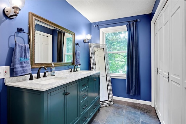 3200 NW 51st Ter, Blue Springs, MO 64015 - bathroom featuring double vanity and stone finish flooring