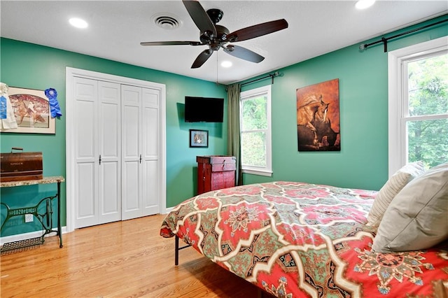 3200 NW 51st Ter, Blue Springs, MO 64015 - bedroom with wood finished floors, recessed lighting, multiple windows, a closet, and ceiling fan