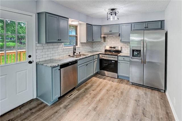 113 SE 250th Rd, Warrensburg, MO 64093 - kitchen with stainless steel appliances, light stone countertops, decorative backsplash, light wood-type flooring, and healthy amount of natural light