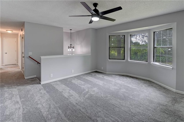 113 SE 250th Rd, Warrensburg, MO 64093 - empty room featuring carpet flooring, a textured ceiling, ceiling fan, and a chandelier