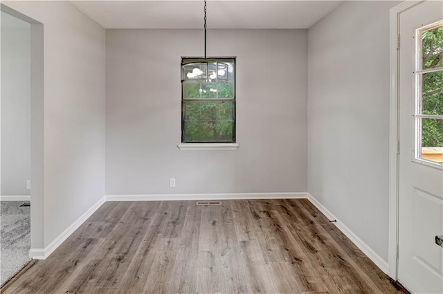 113 SE 250th Rd, Warrensburg, MO 64093 - unfurnished dining area with wood finished floors and a chandelier