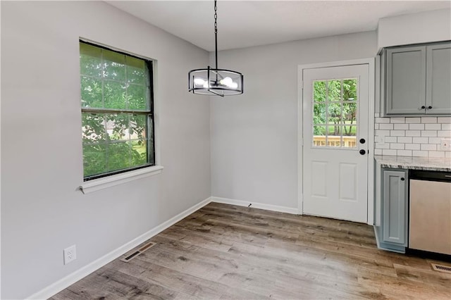 113 SE 250th Rd, Warrensburg, MO 64093 - unfurnished dining area featuring a chandelier and light wood-style flooring