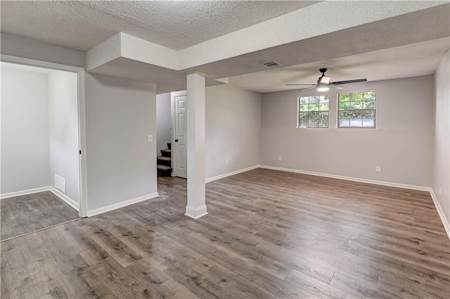 113 SE 250th Rd, Warrensburg, MO 64093 - below grade area featuring wood finished floors, stairway, a ceiling fan, and a textured ceiling