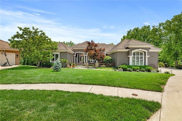 8709 Pine St, Lenexa, KS 66220 - view of front of property with a front lawn, stucco siding, and a tiled roof