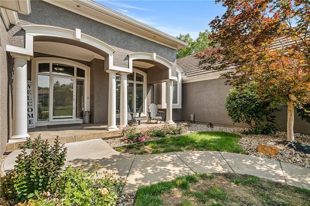 8709 Pine St, Lenexa, KS 66220 - property entrance featuring stucco siding and covered porch