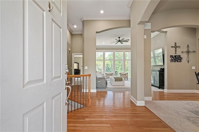 8709 Pine St, Lenexa, KS 66220 - foyer with arched walkways, a ceiling fan, ornamental molding, light wood-style floors, and recessed lighting