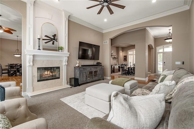 8709 Pine St, Lenexa, KS 66220 - living area with ceiling fan, arched walkways, ornamental molding, recessed lighting, and a premium fireplace
