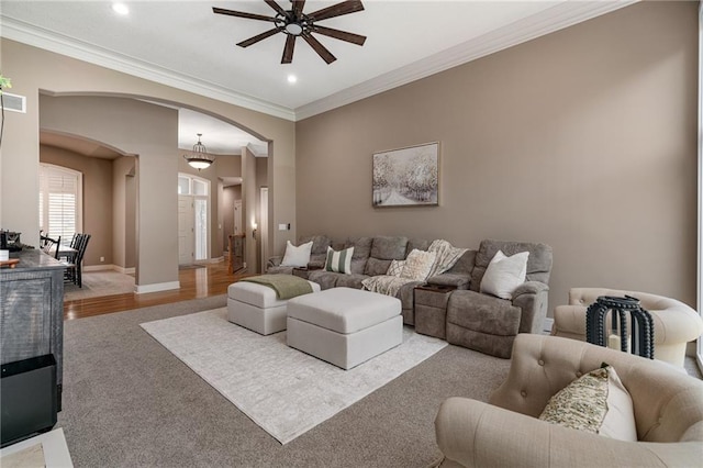 8709 Pine St, Lenexa, KS 66220 - carpeted living area featuring arched walkways, ceiling fan, recessed lighting, and crown molding